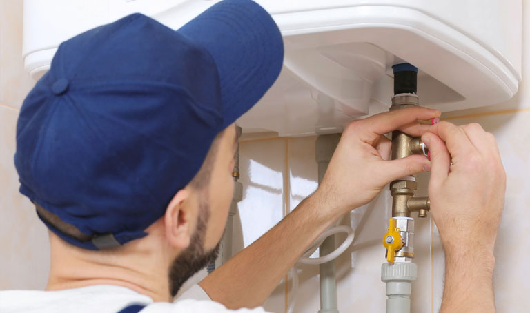 Plumber fixing a boiler